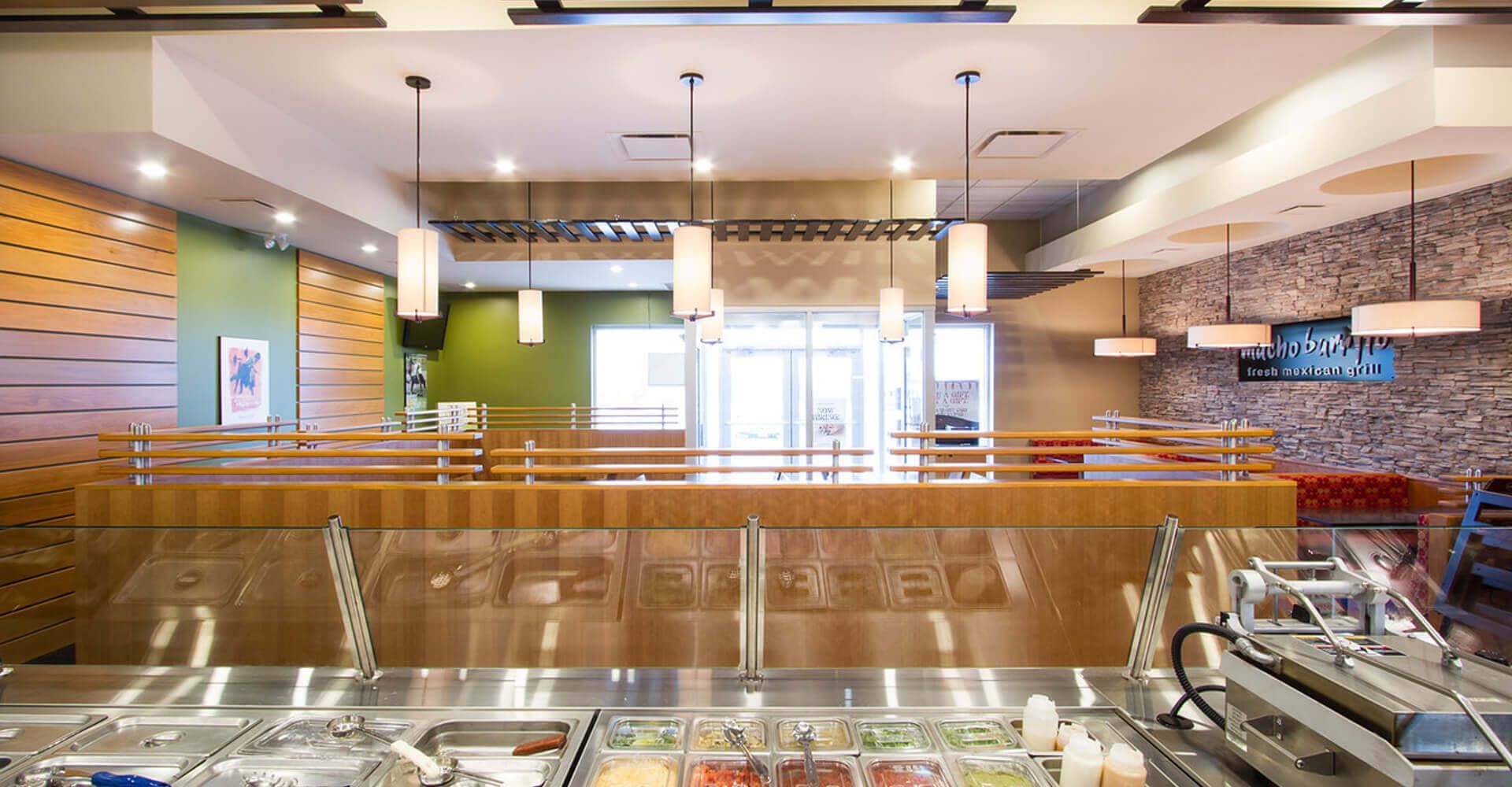 A buffet line in a restaurant with a lot of food on it