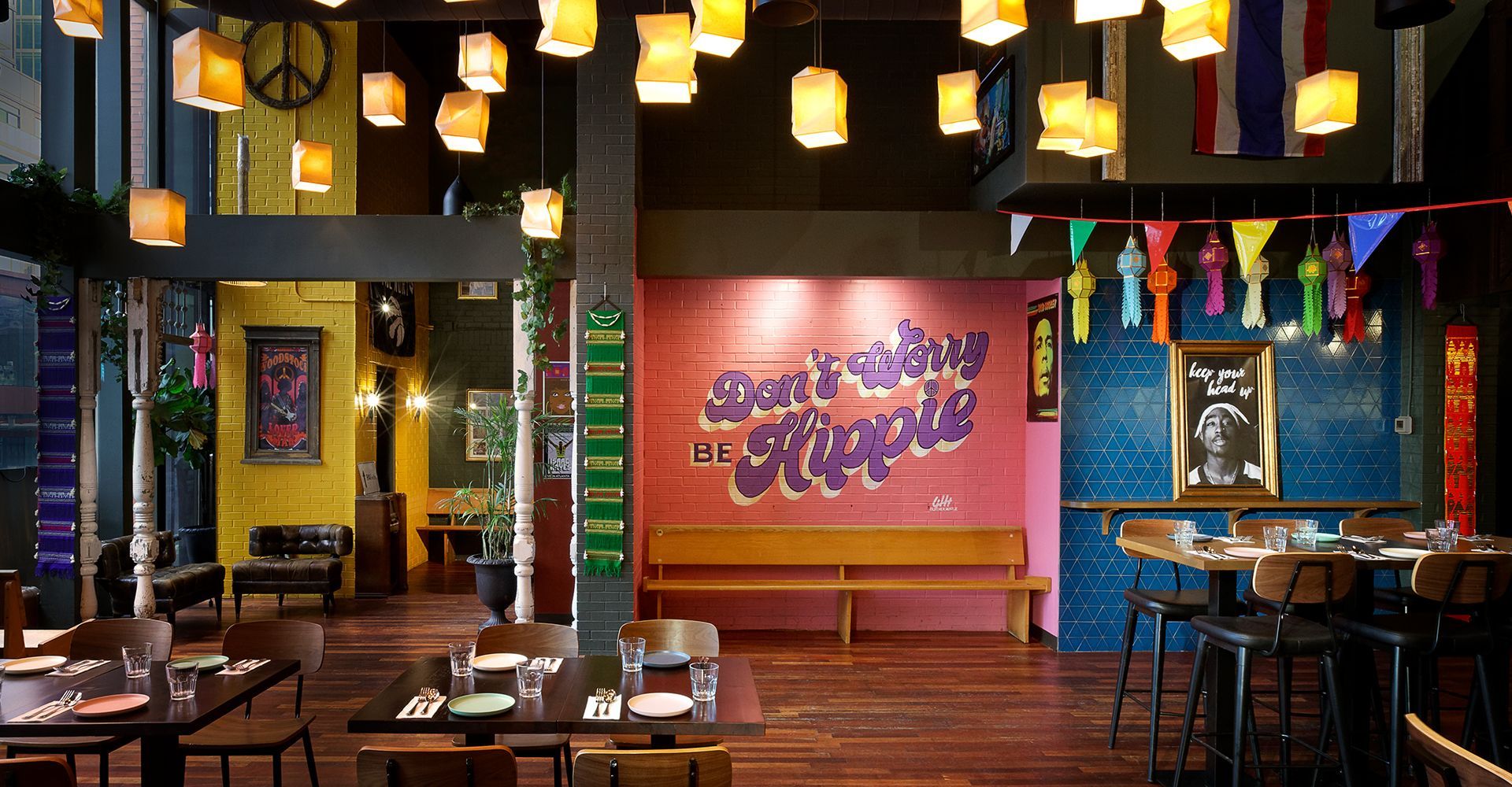 A restaurant with tables and chairs and a peace sign on the wall