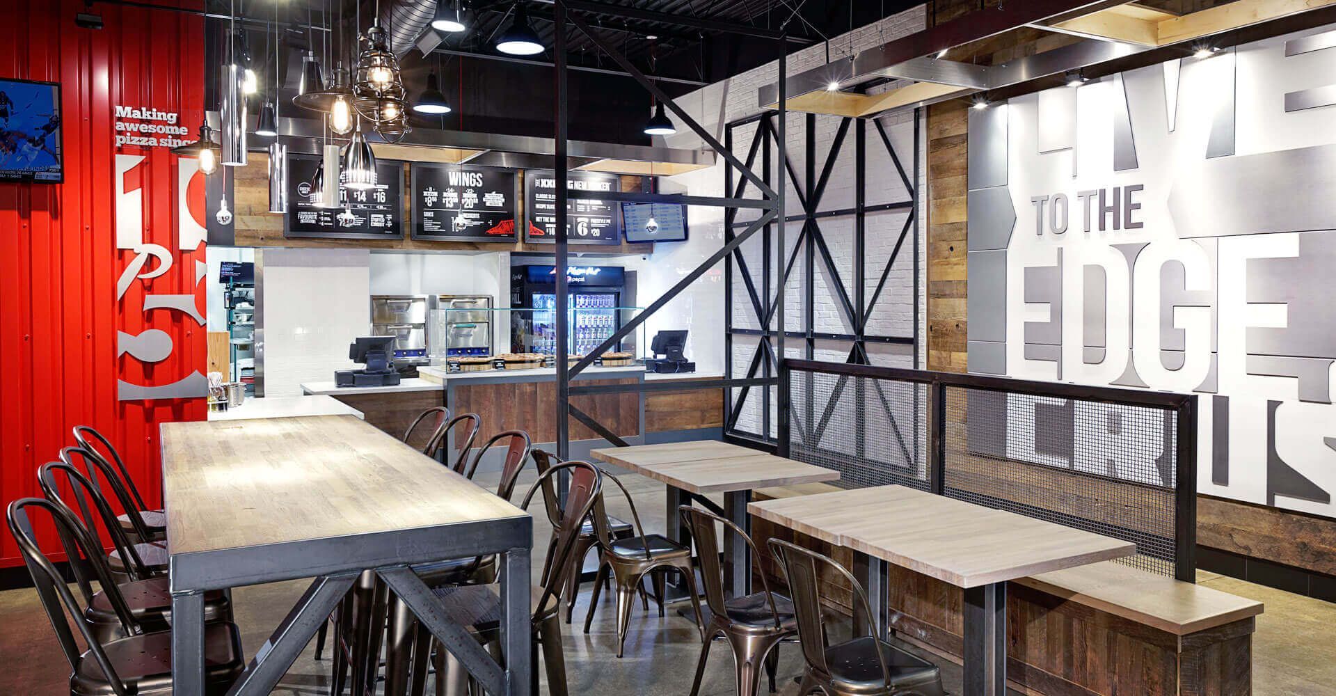 A restaurant with tables and chairs and a sign that says `` to the edge ''.