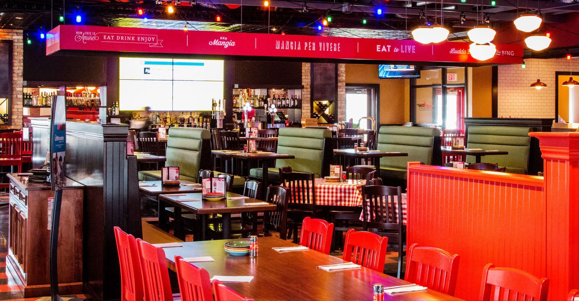 A restaurant filled with tables and chairs and christmas lights.