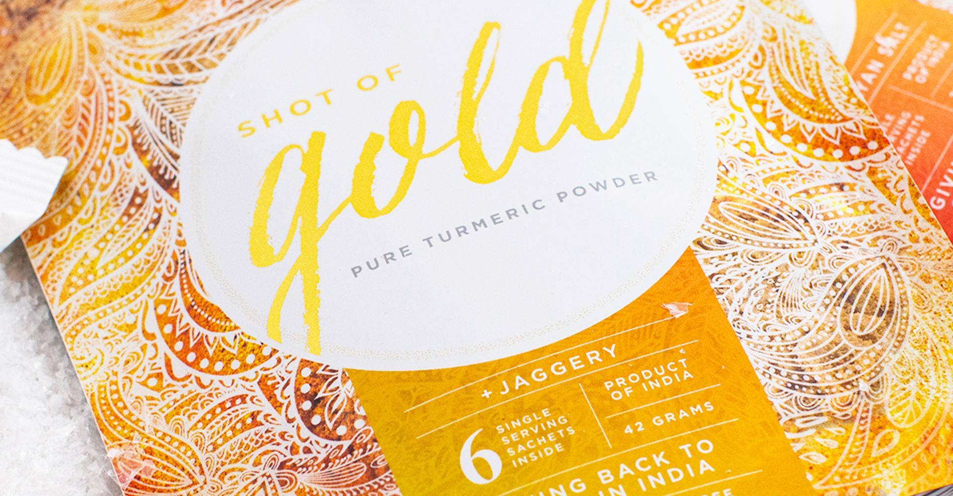 A close up of a bag of turmeric powder on a table.