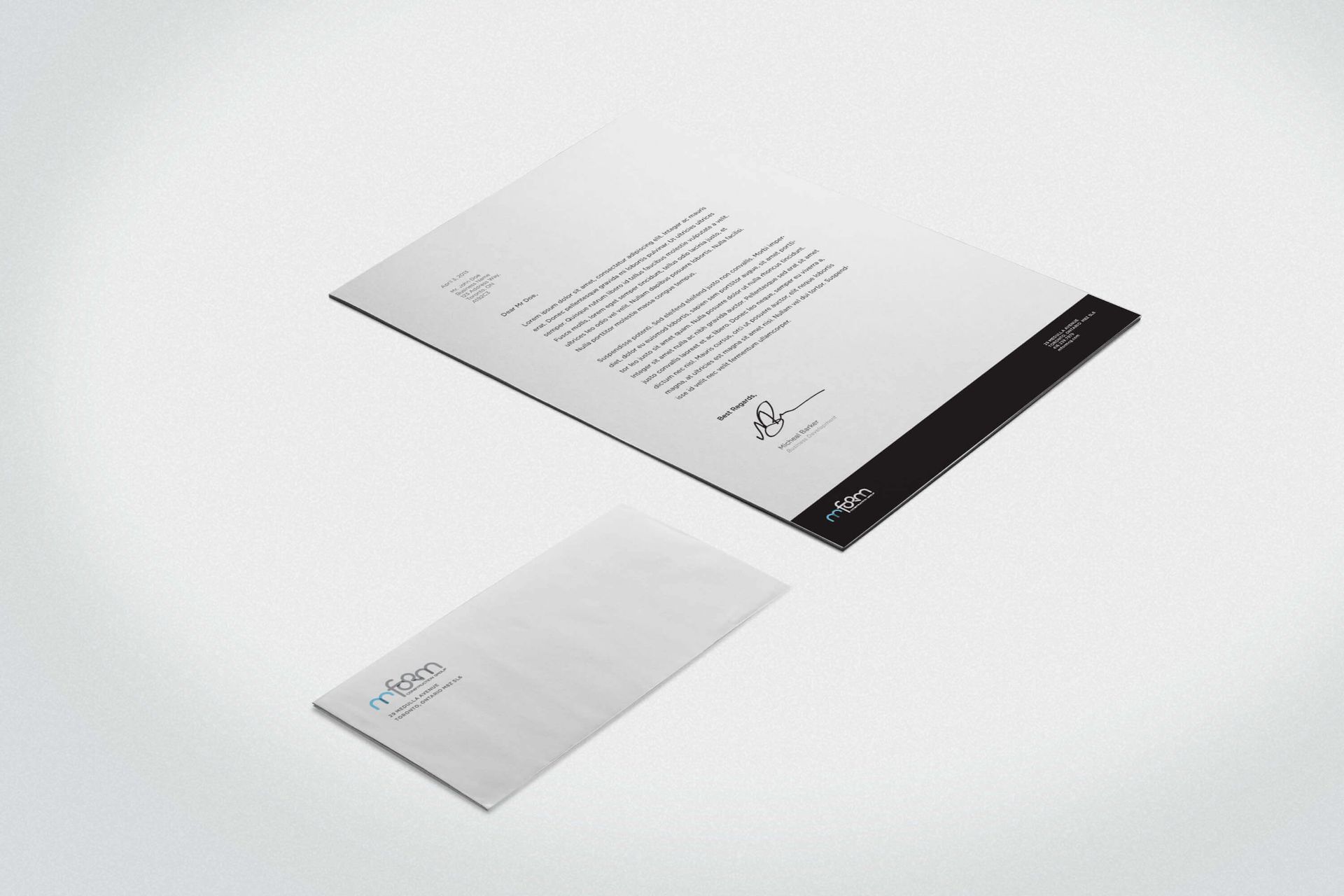 A letterhead and envelope are on a white surface.