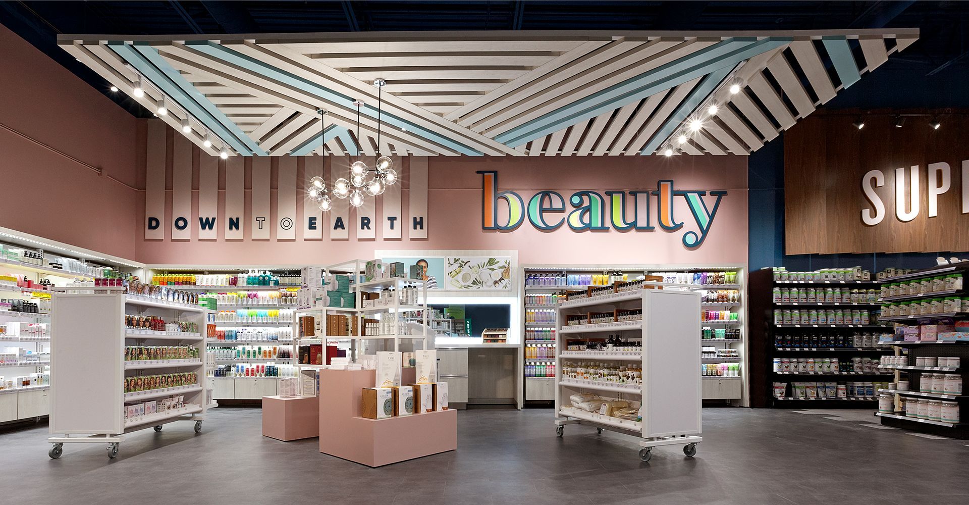 A beauty store with a pink wall and a blue ceiling.