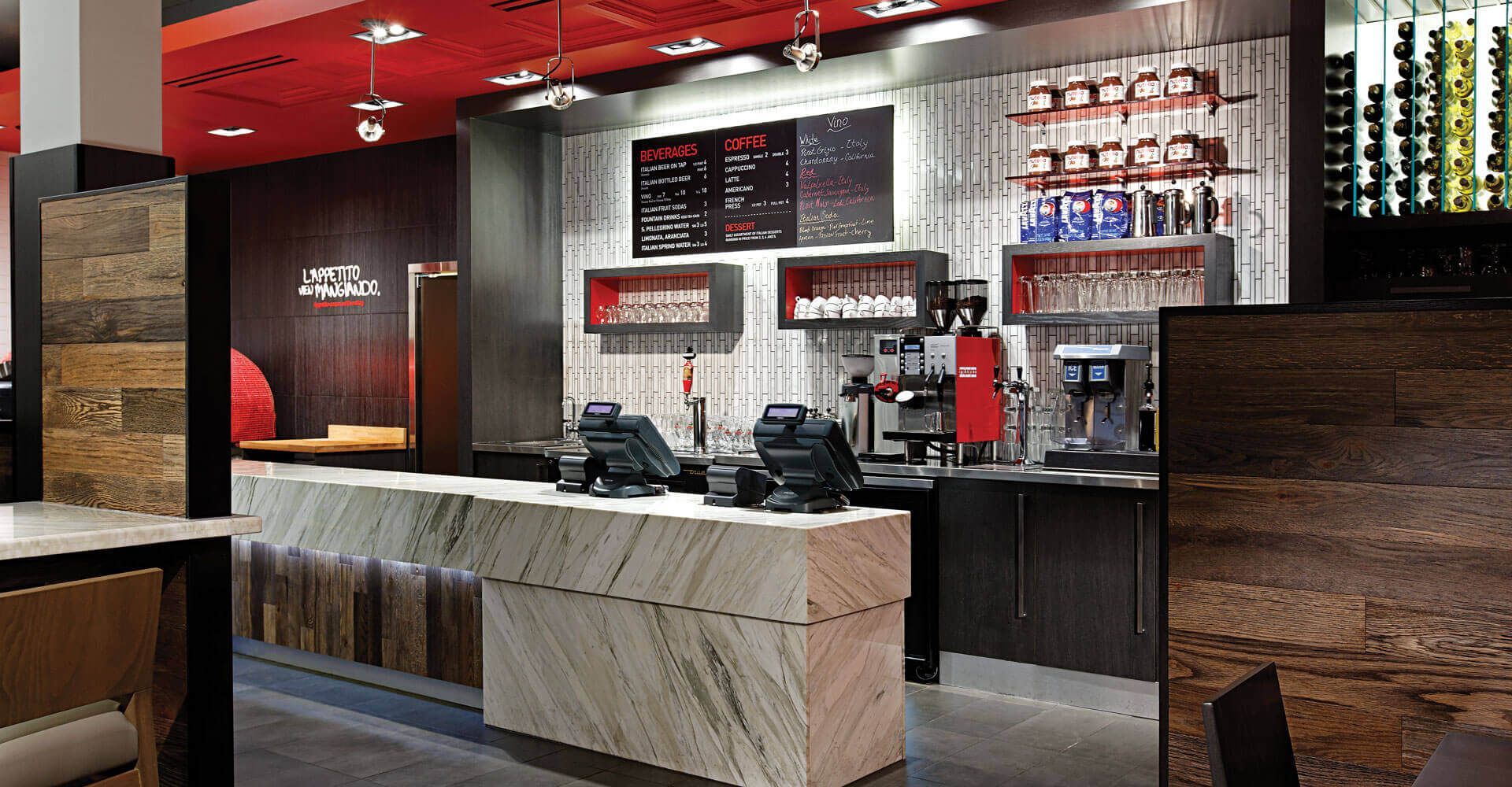 A restaurant with a marble counter and a red ceiling