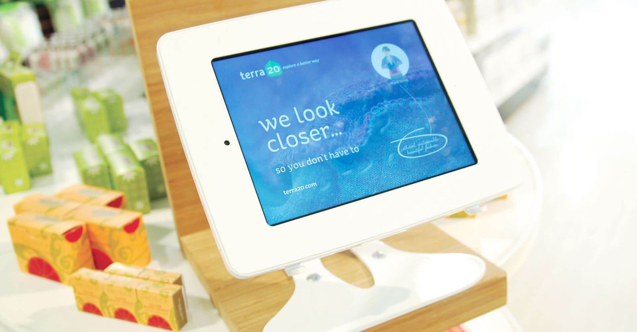 A tablet with the words `` we look closer '' on the screen is sitting on a table.