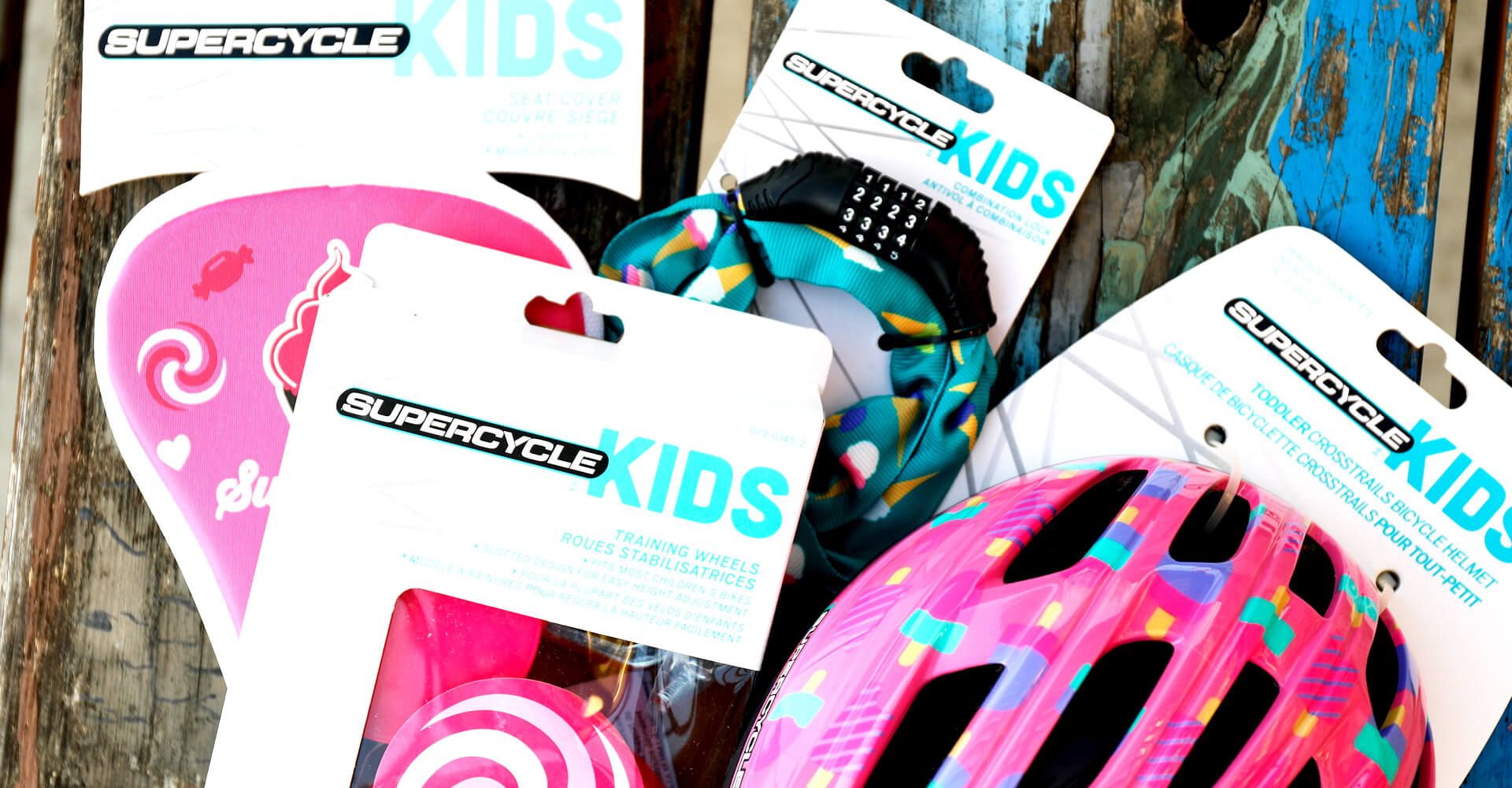 A bunch of kids bicycle helmets are sitting on a wooden table.