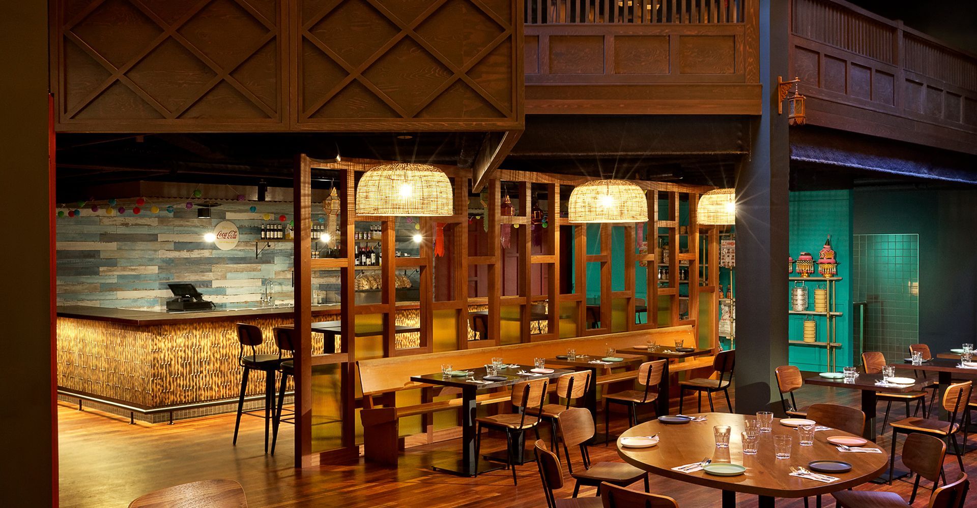 A restaurant with tables and chairs and a bar in the background.