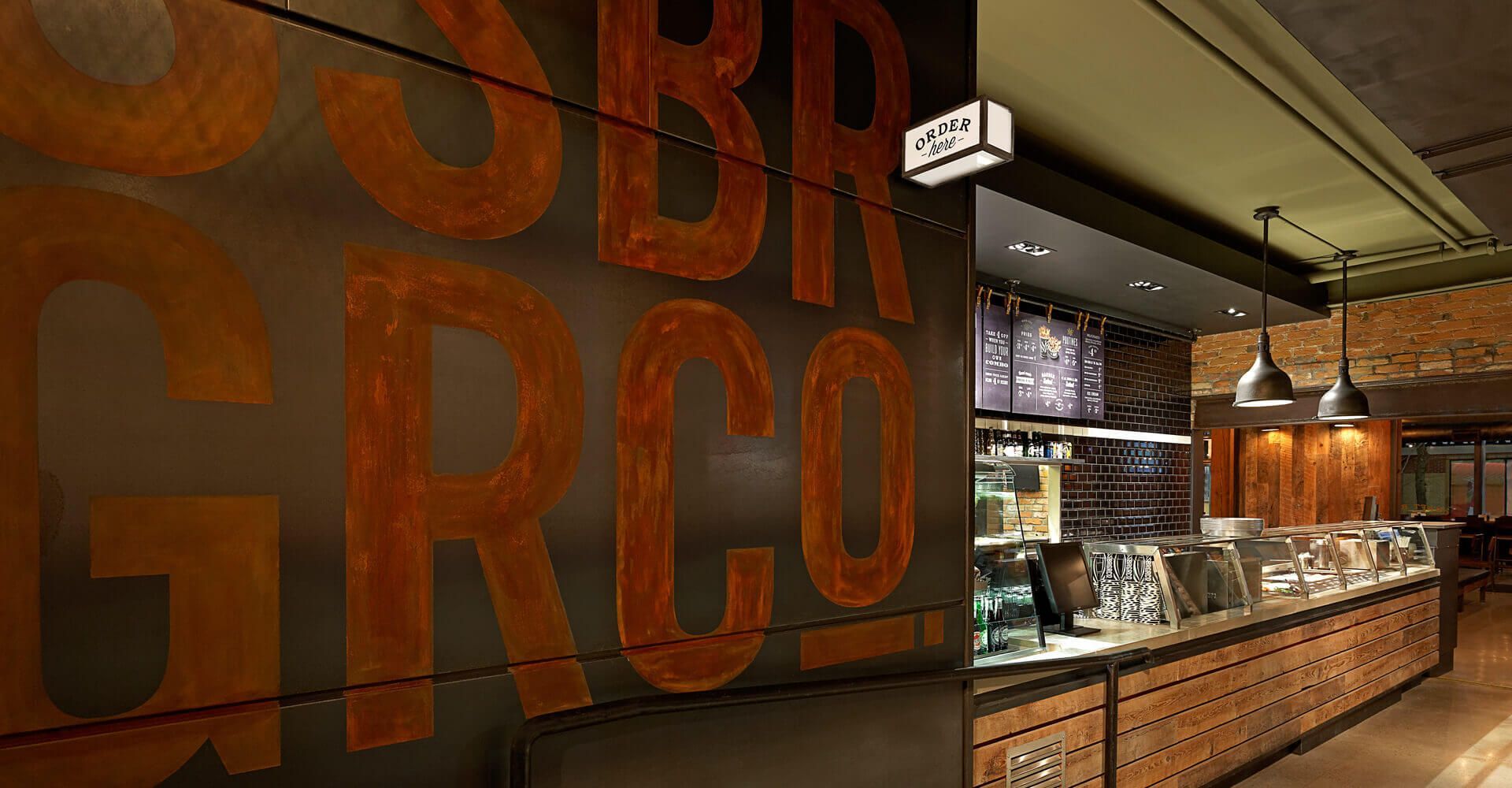 A restaurant with a large sign on the wall that says grco