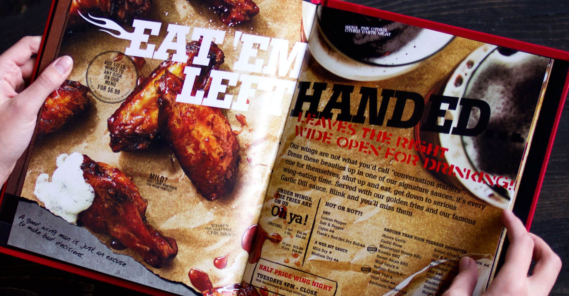 A person is holding a menu that says eat em led handed