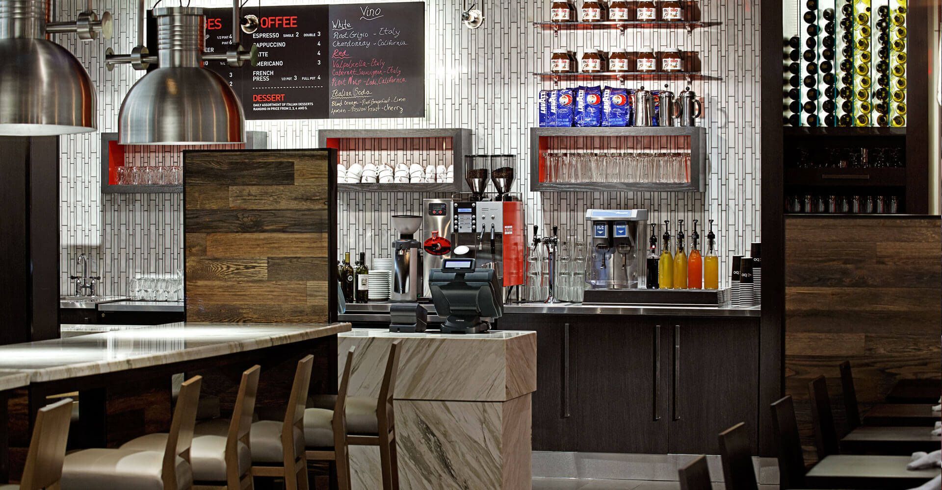 A restaurant with a bar , tables and chairs.