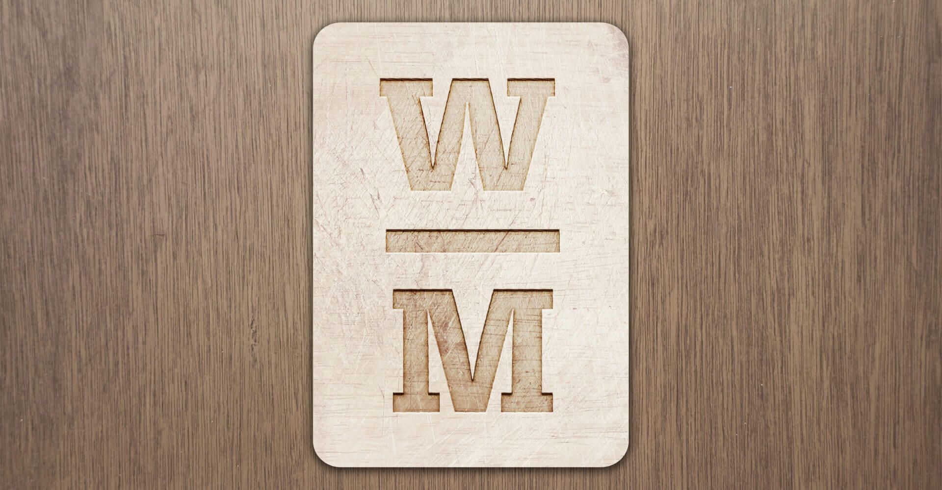 A wooden sign with the letter w and m cut out of it