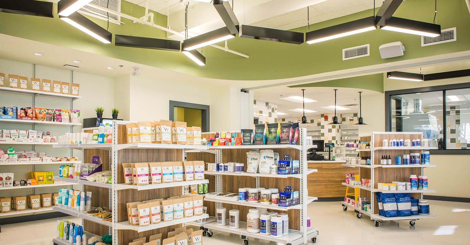 A pharmacy with lots of shelves and a counter.