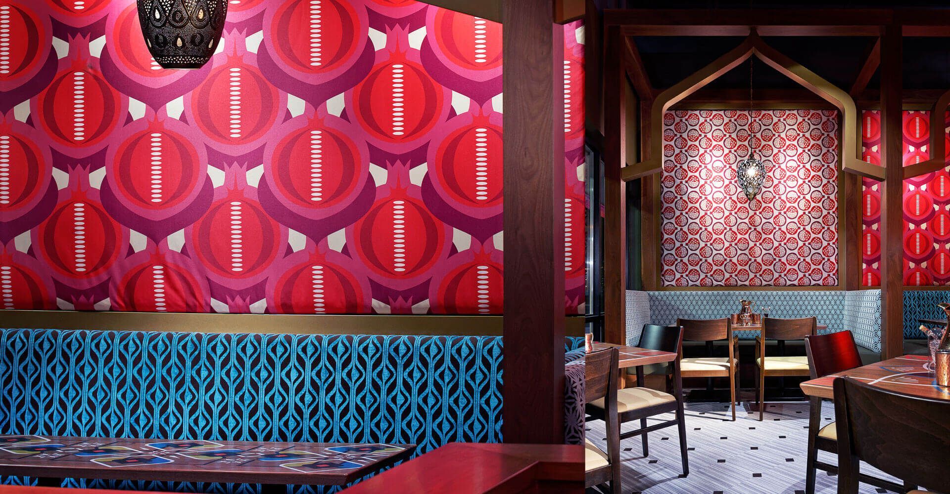 A restaurant with tables and chairs and a patterned wall