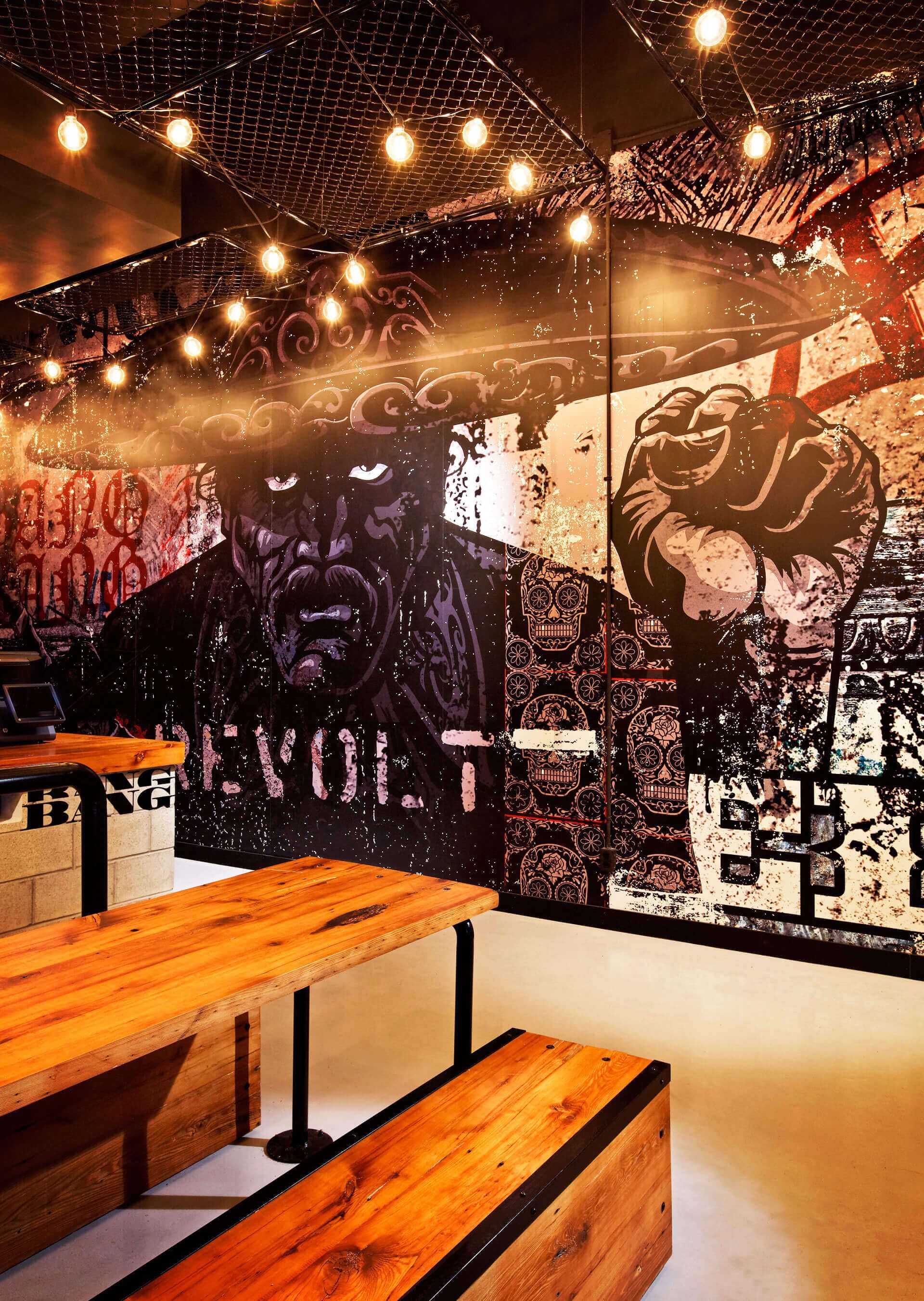 A room with a mural on the wall that says revolt