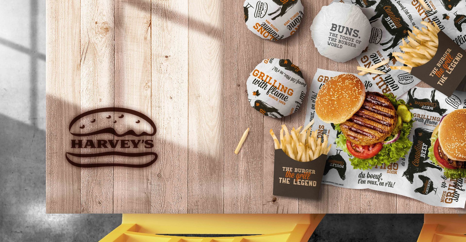 A wooden table topped with hamburgers and french fries.