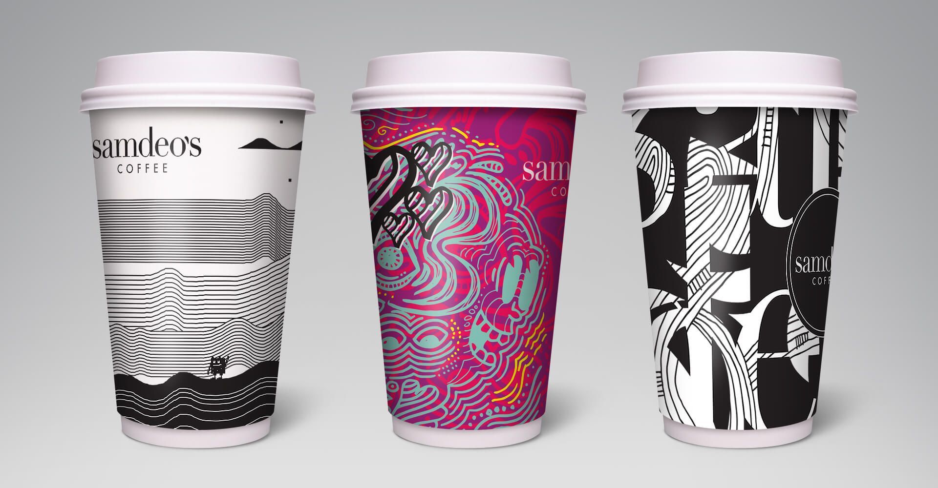 Three coffee cups with different designs on them are sitting next to each other on a table.