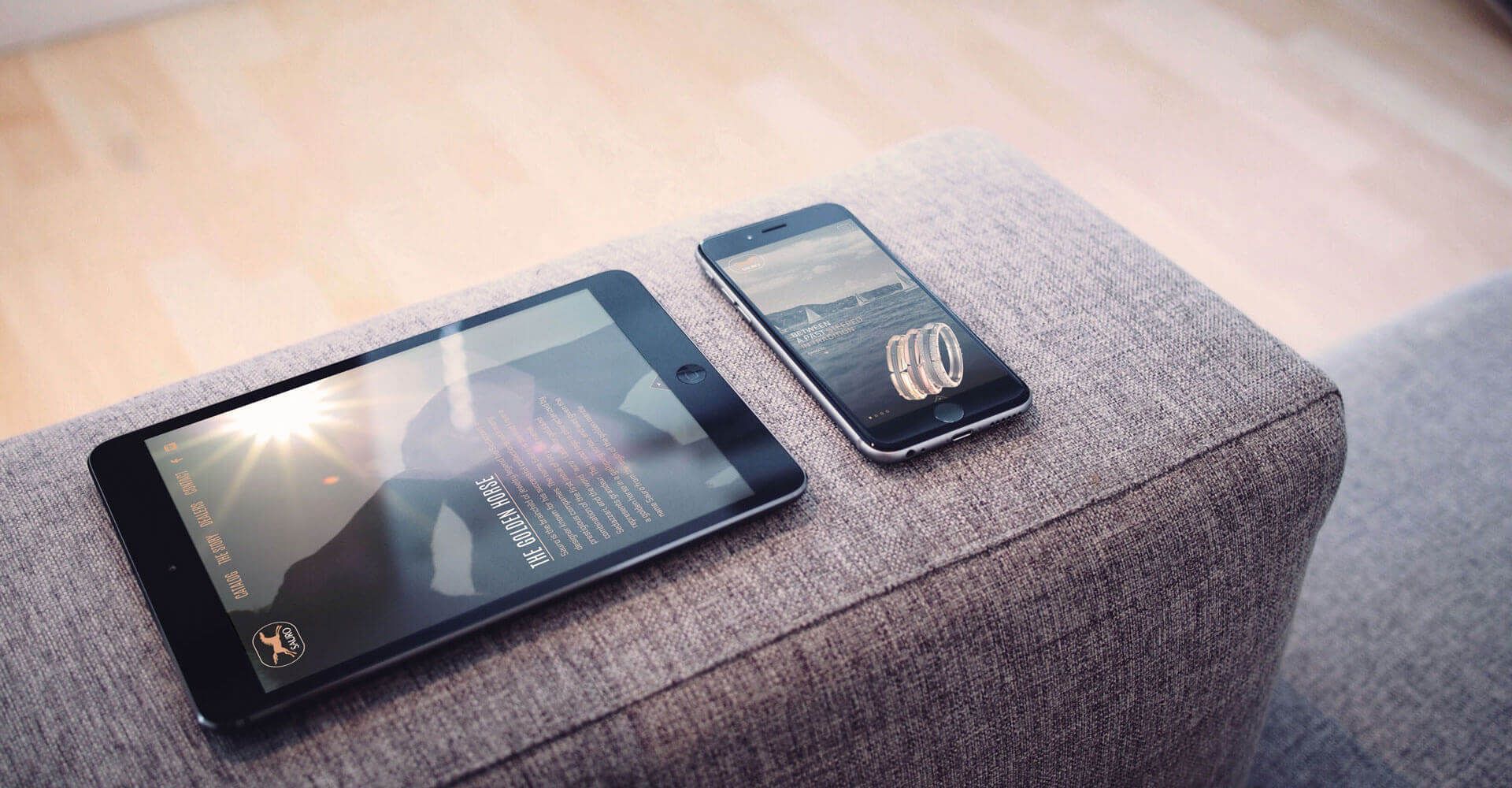 A tablet and a cell phone are sitting on a table.