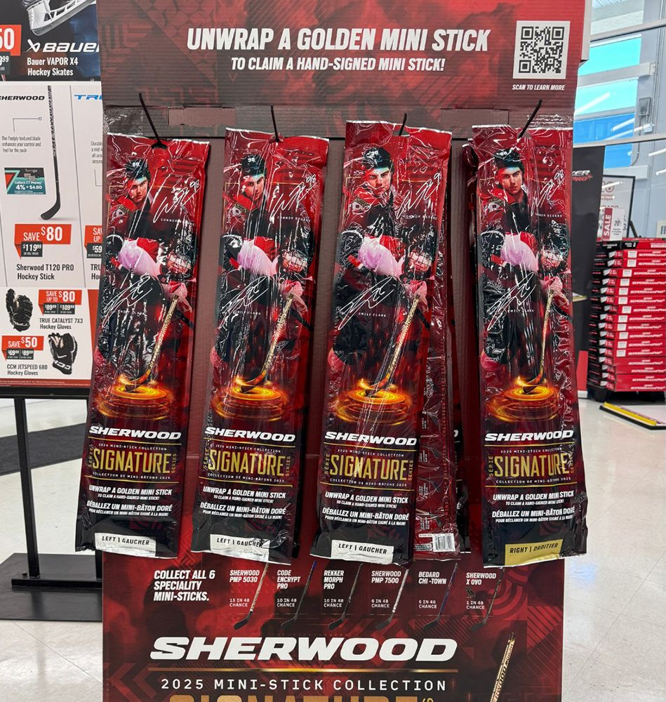 A plate of shrimp is sitting on a table next to a coconut and garlic.