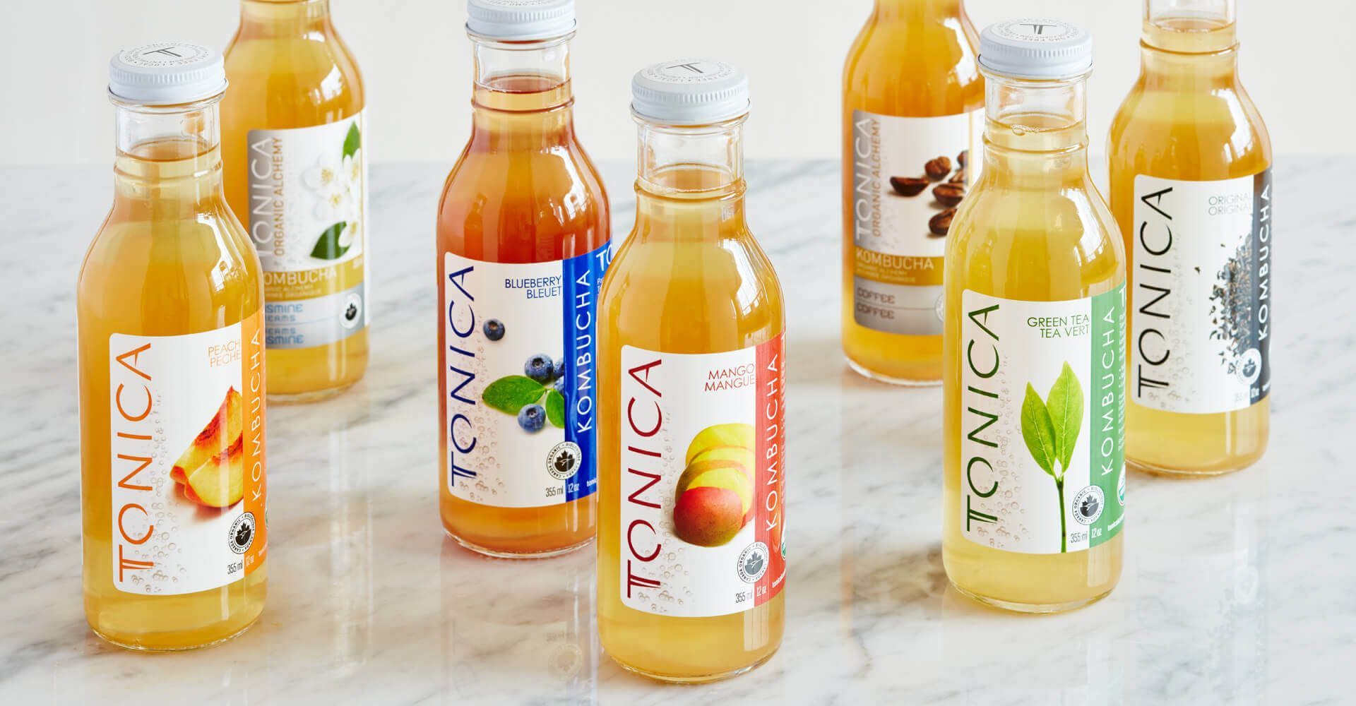 A group of bottles of tonic juice are sitting on a table.