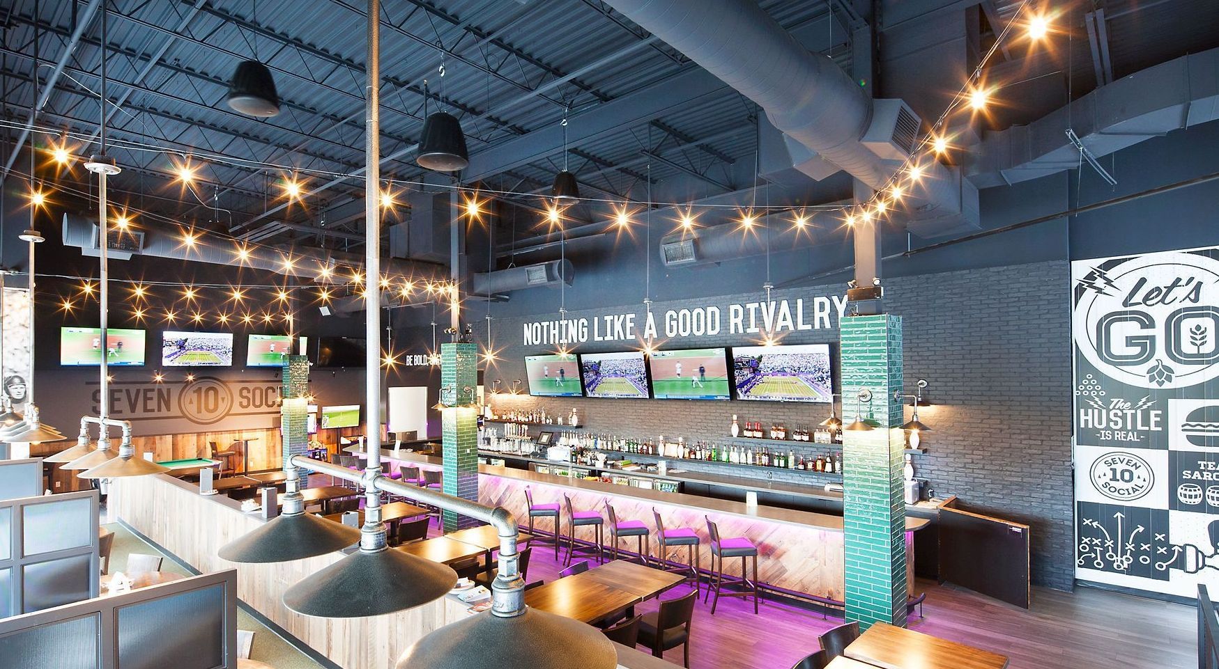 The inside of a restaurant with tables and chairs and a bar.