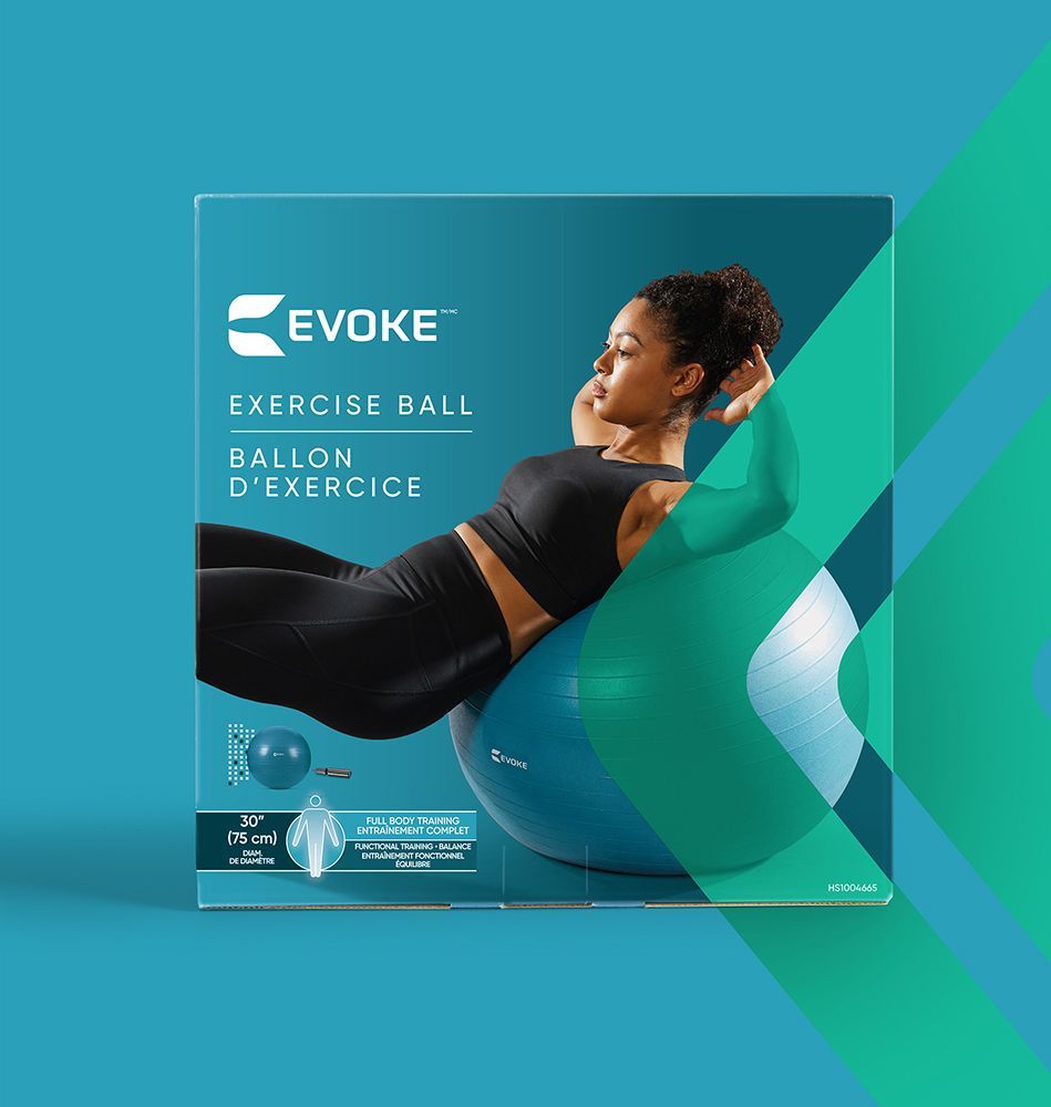 A woman is laying on a blue exercise ball in a box.