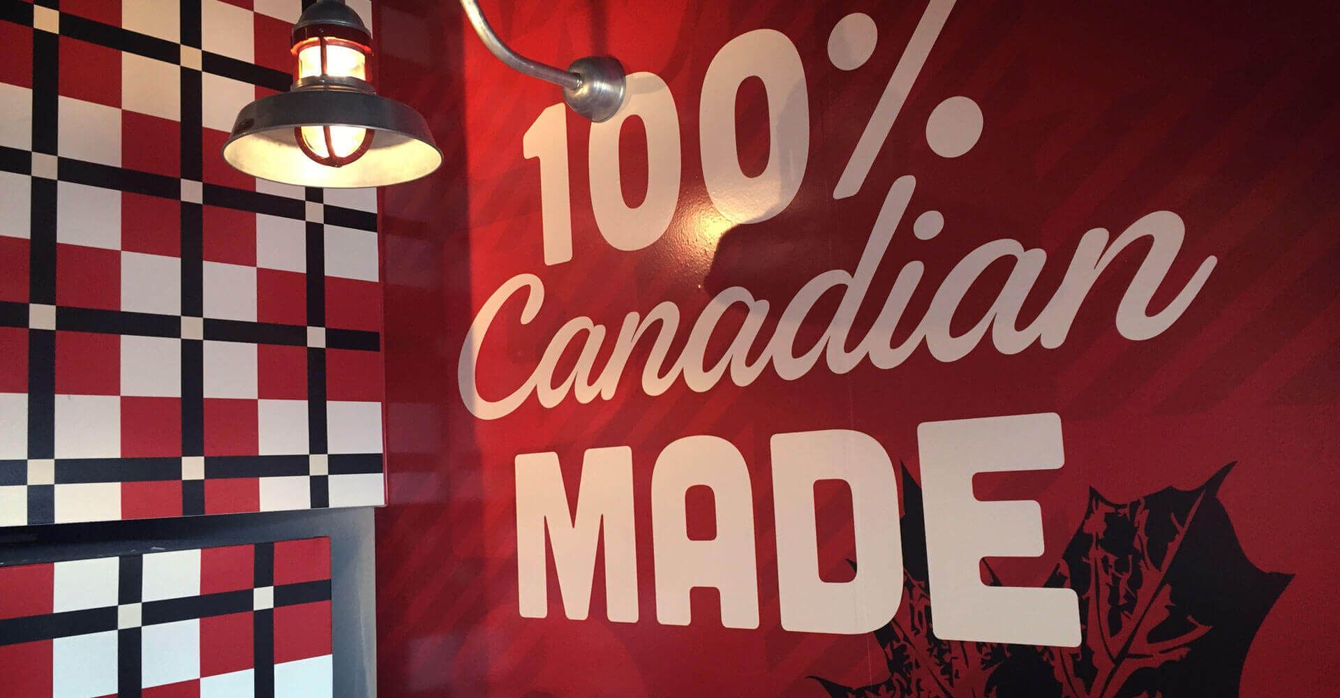 A sign on a wall that says 100 % canadian made