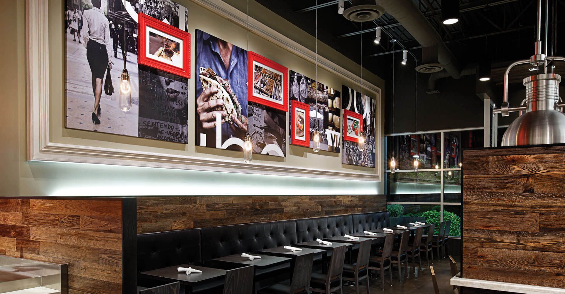A restaurant with tables and chairs and pictures on the wall