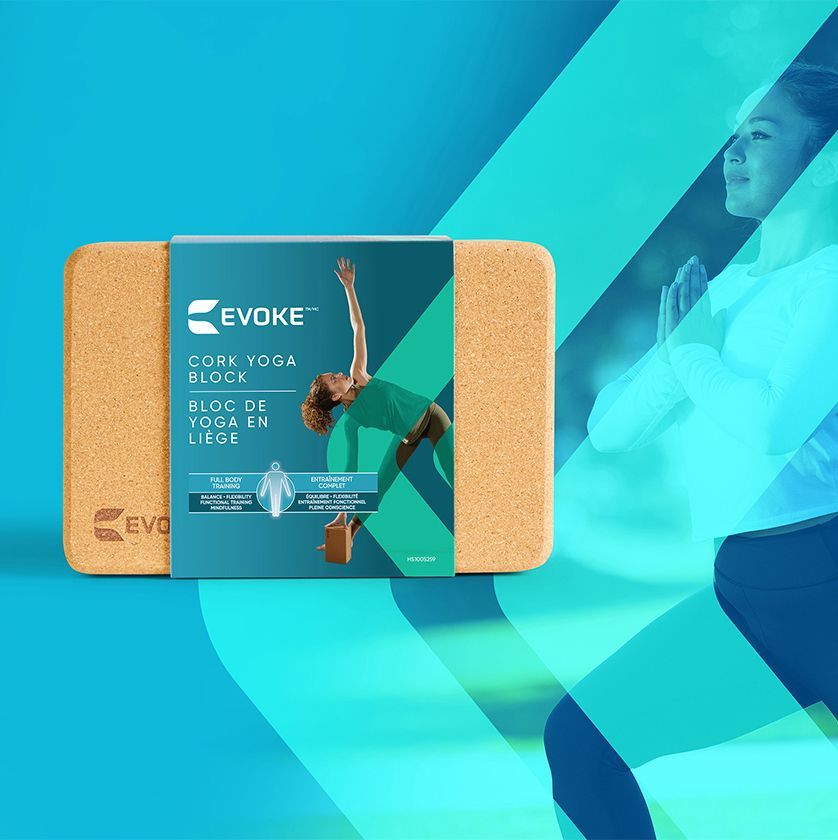 A woman is doing a yoga pose on a cork yoga block.