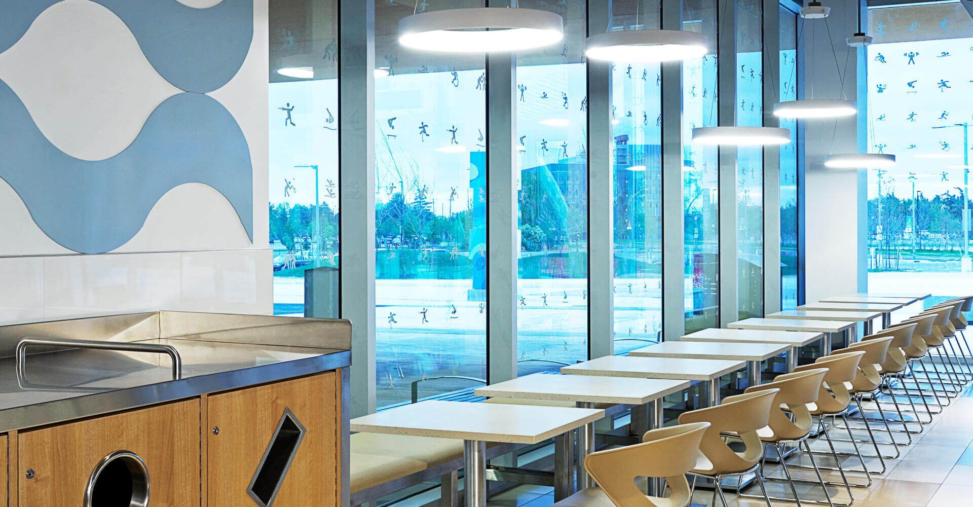 A long row of tables and chairs in a restaurant