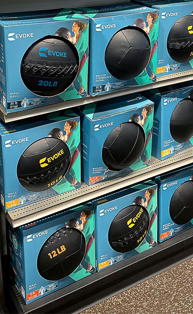 A shelf filled with boxes of exercise balls in a store.