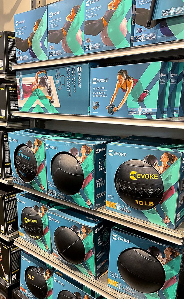 A shelf filled with boxes of exercise balls in a store.