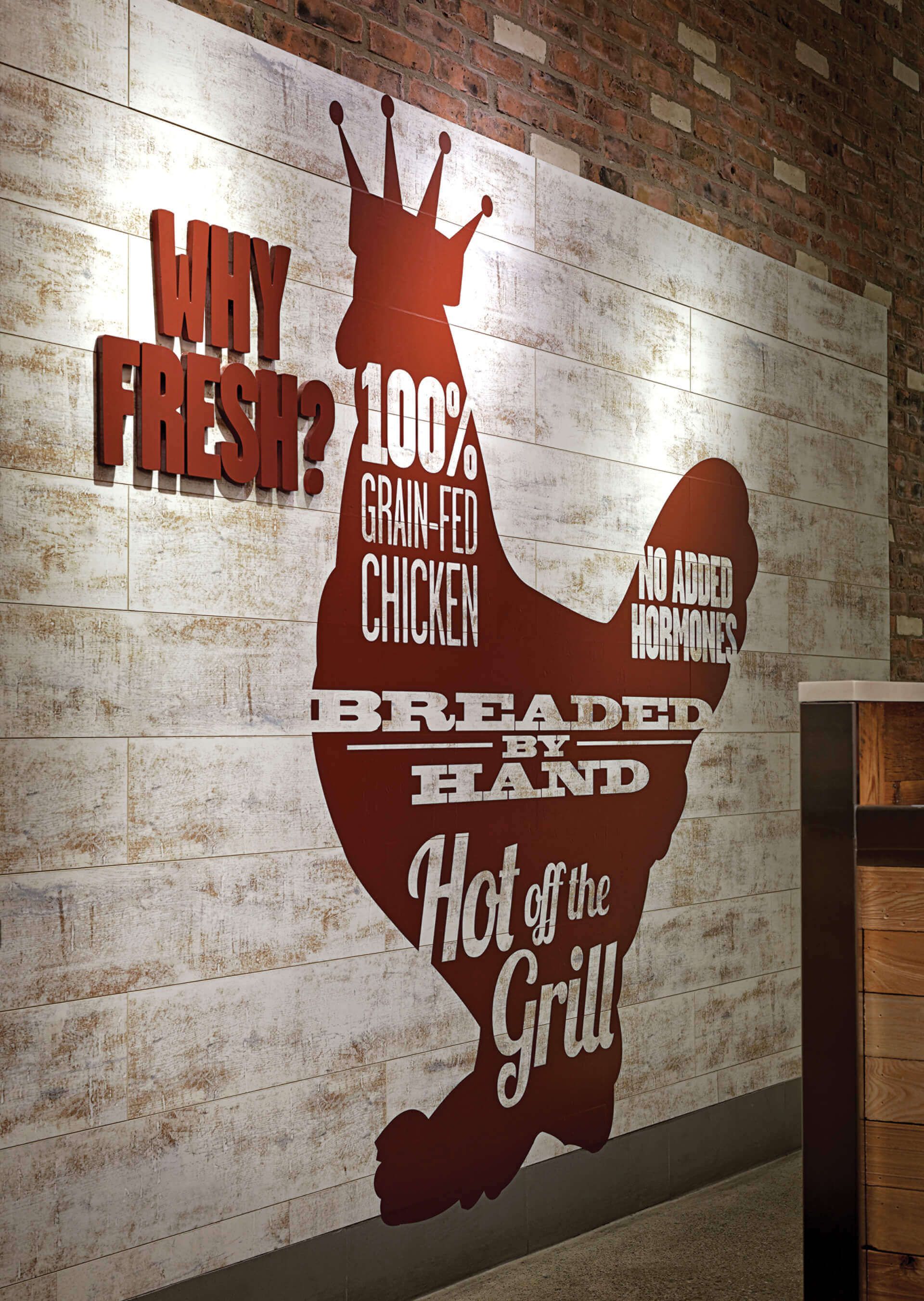 A sign on a wall that says why fresh 100 % breaded chicken