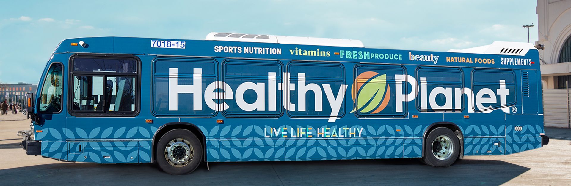 A blue bus with the words healthy planet painted on it