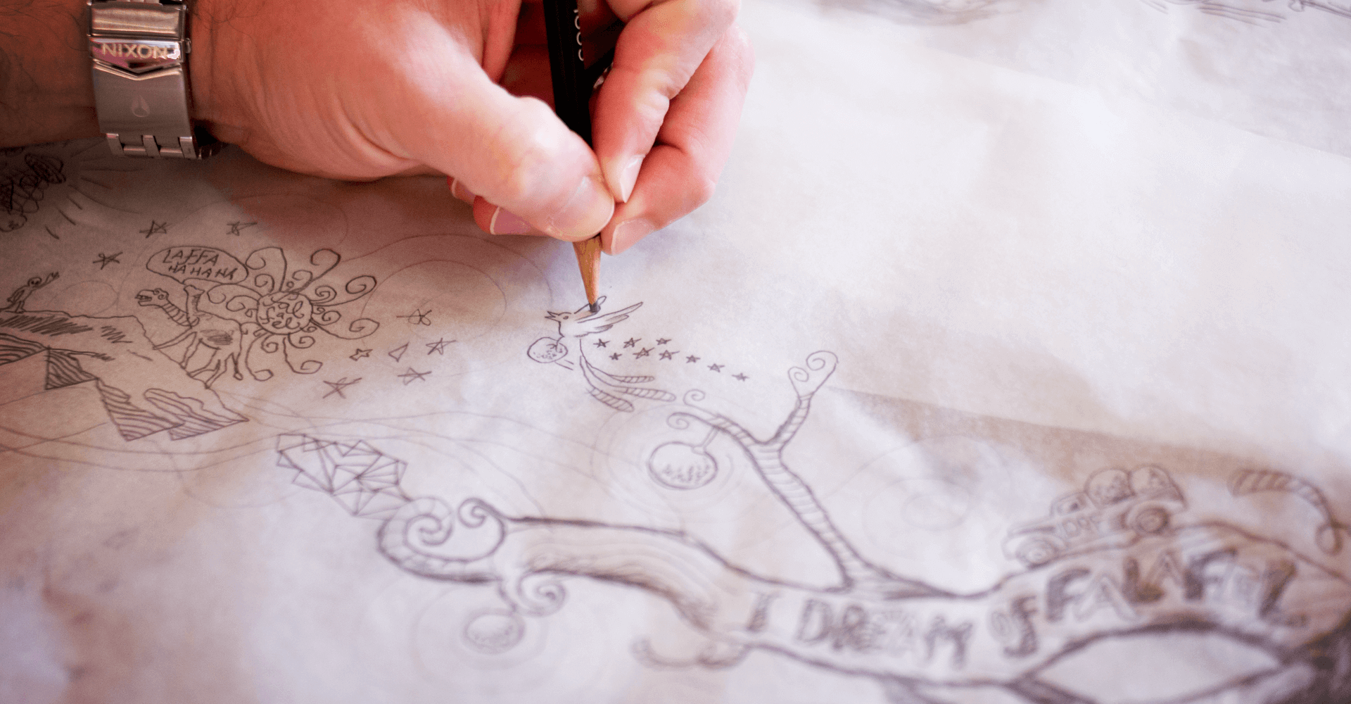 A person is drawing a picture with a pencil on a piece of paper.