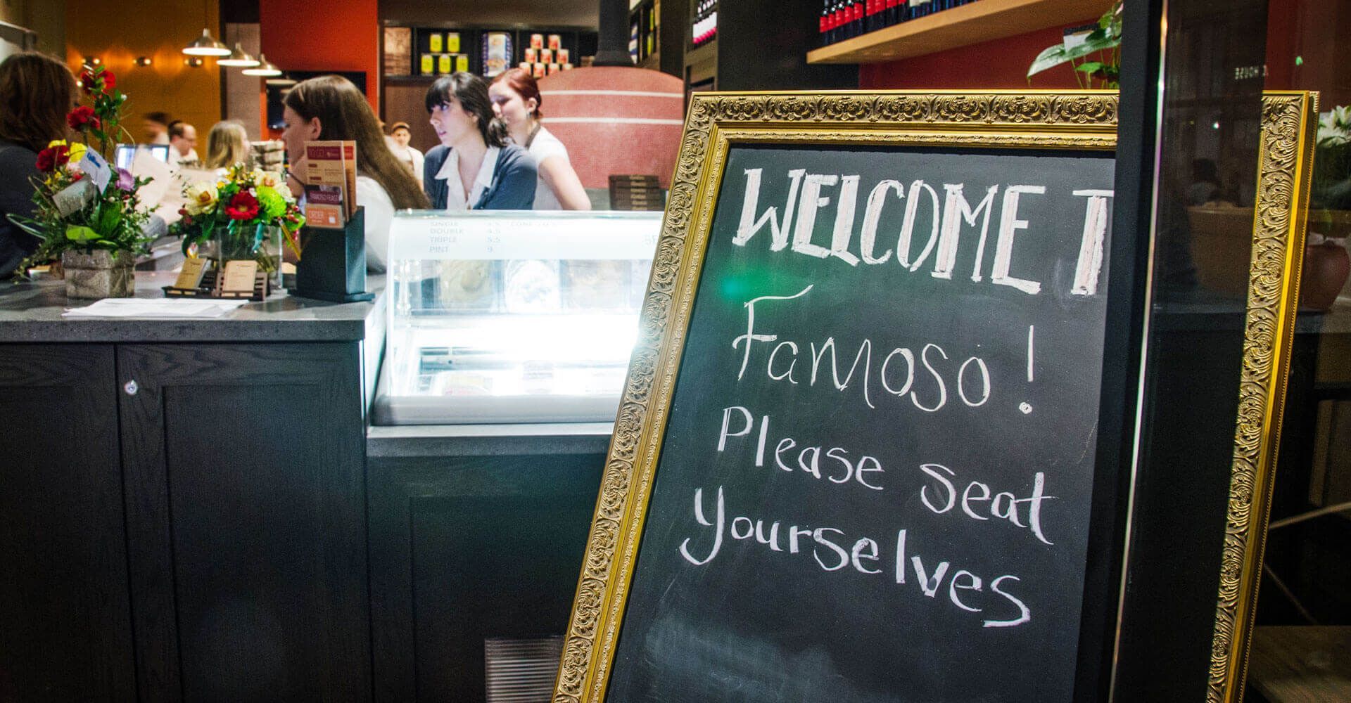 A chalkboard sign that says welcome famous please seal yourselves