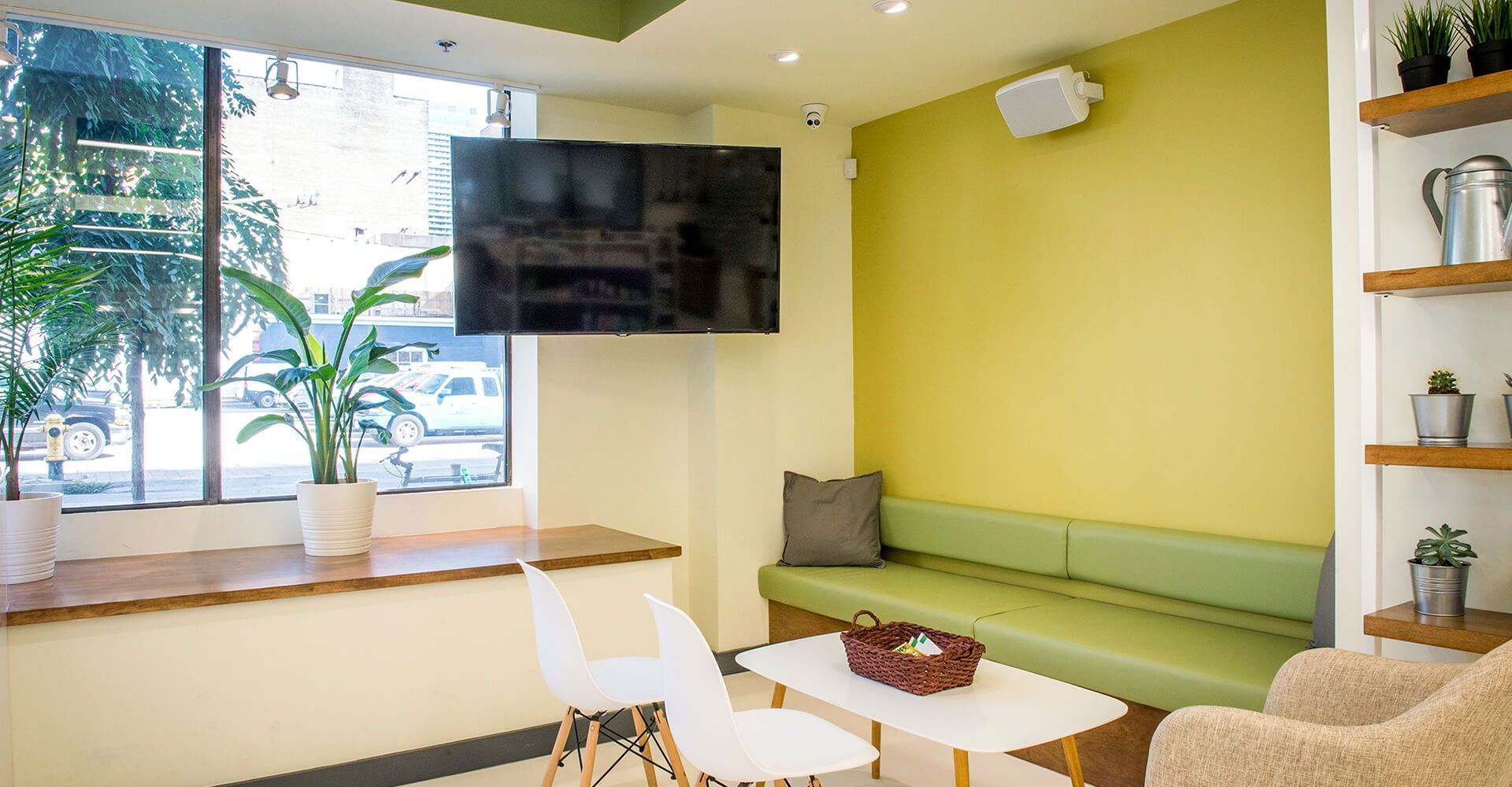 A living room with a couch , chairs , table and television.