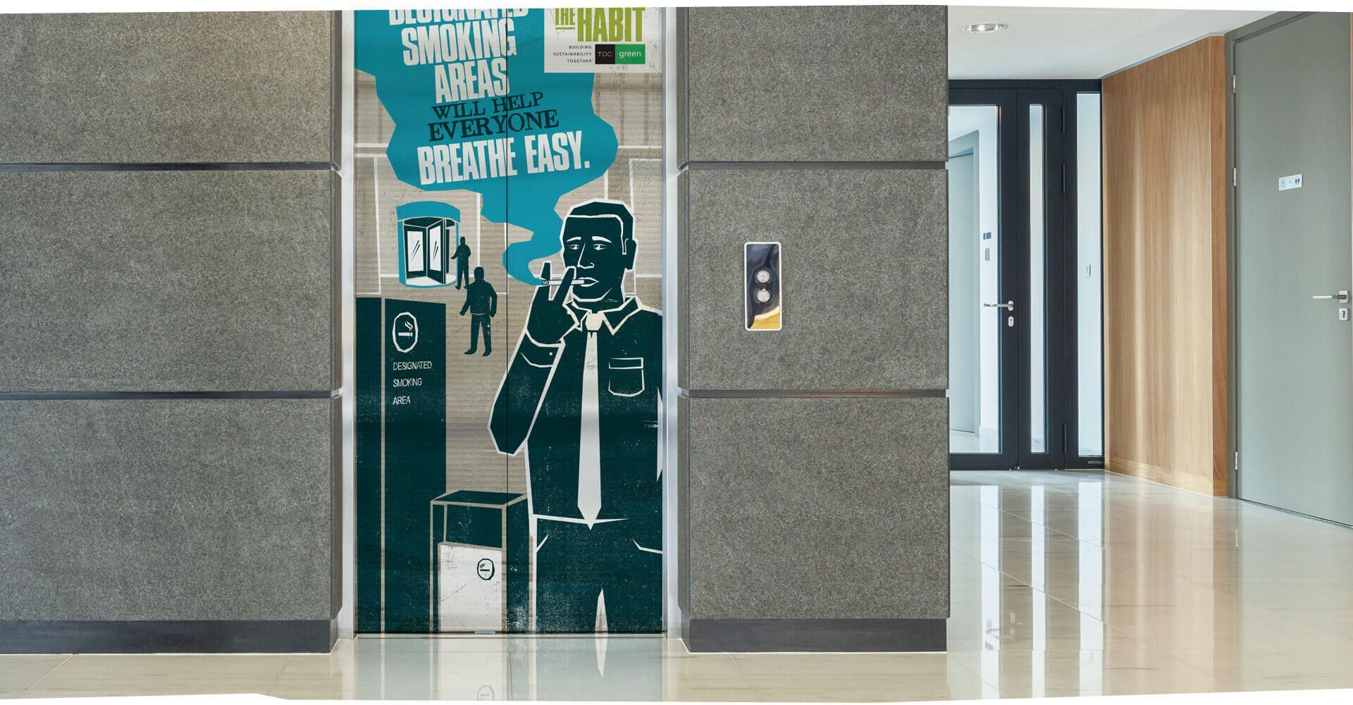 An elevator with a cartoon of a man talking on a phone