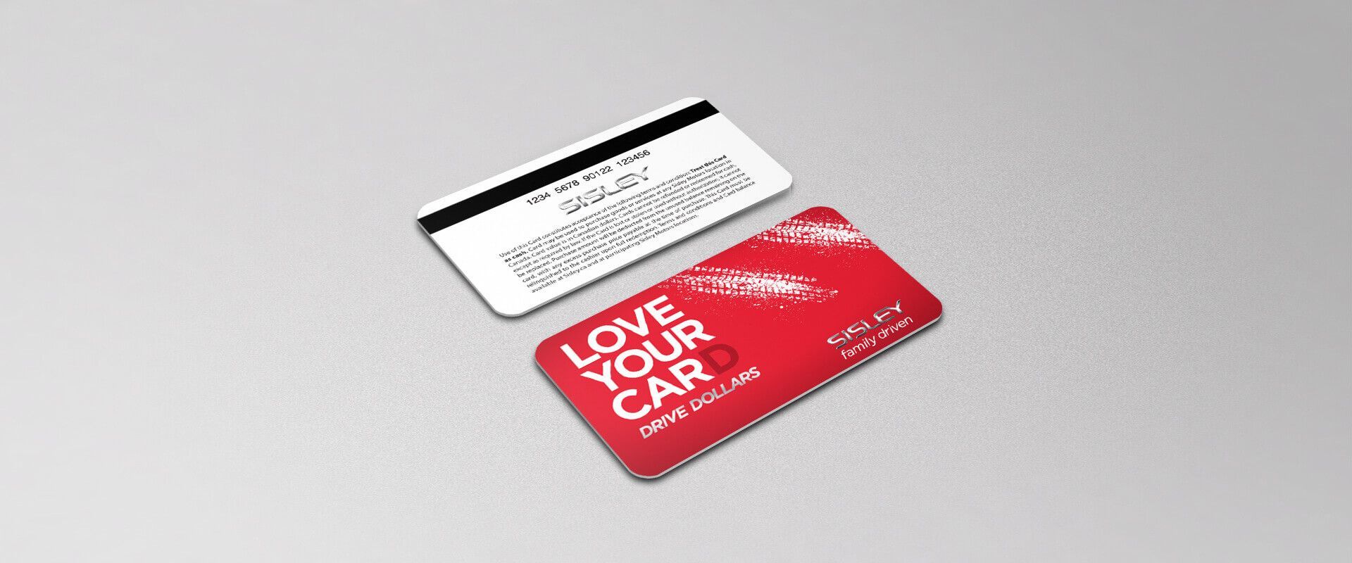 A red and white card that says `` love your car '' is sitting on a table.
