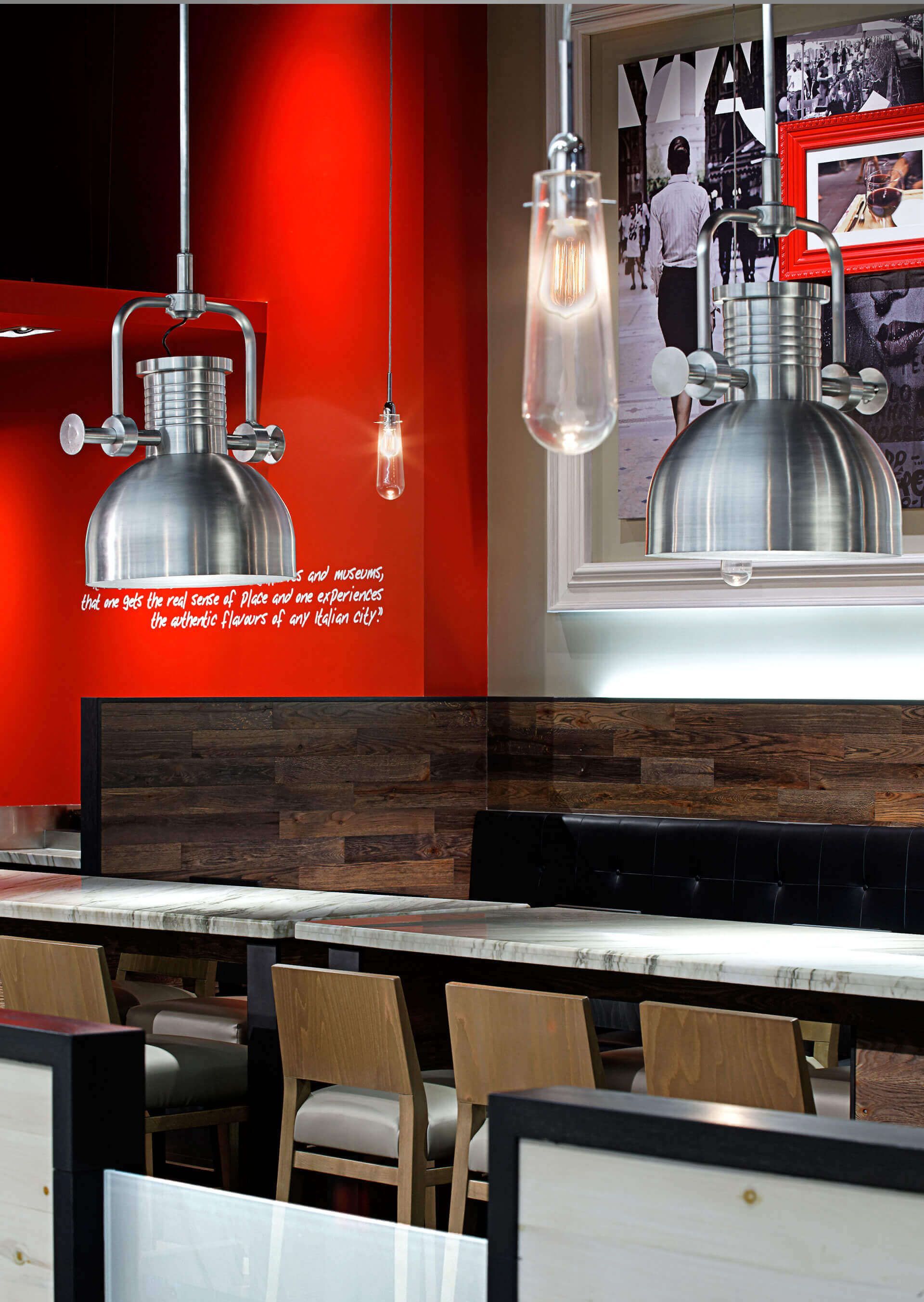 A restaurant with tables and chairs and a red wall