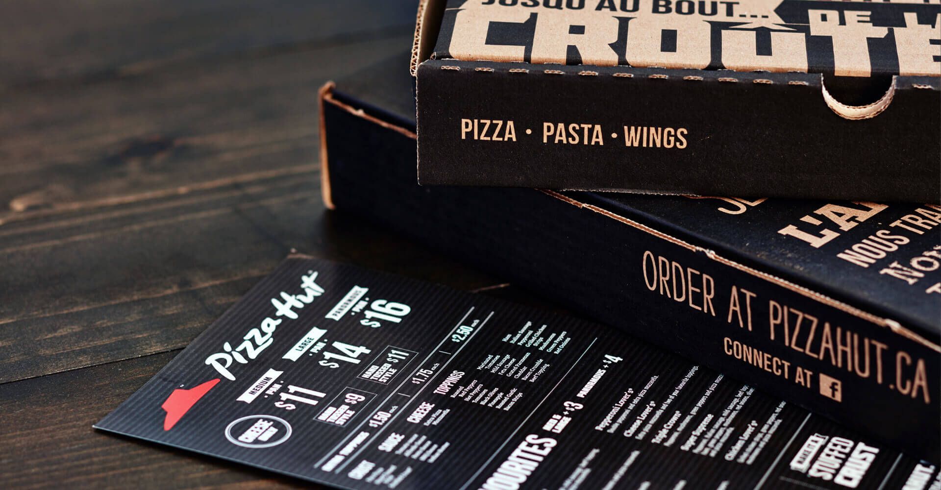 Two pizza hut boxes are stacked on top of each other