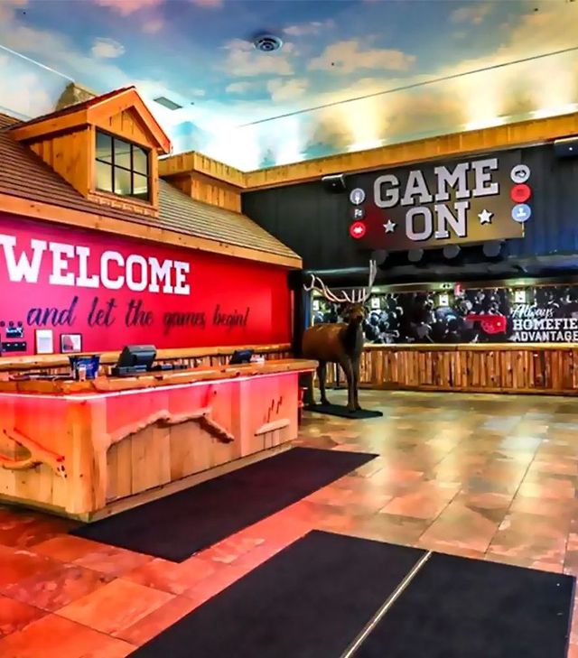 A game on sign hangs above a welcome sign