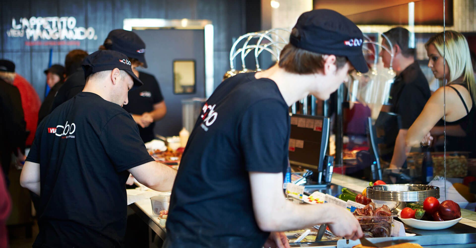 A group of people are preparing food in a restaurant.