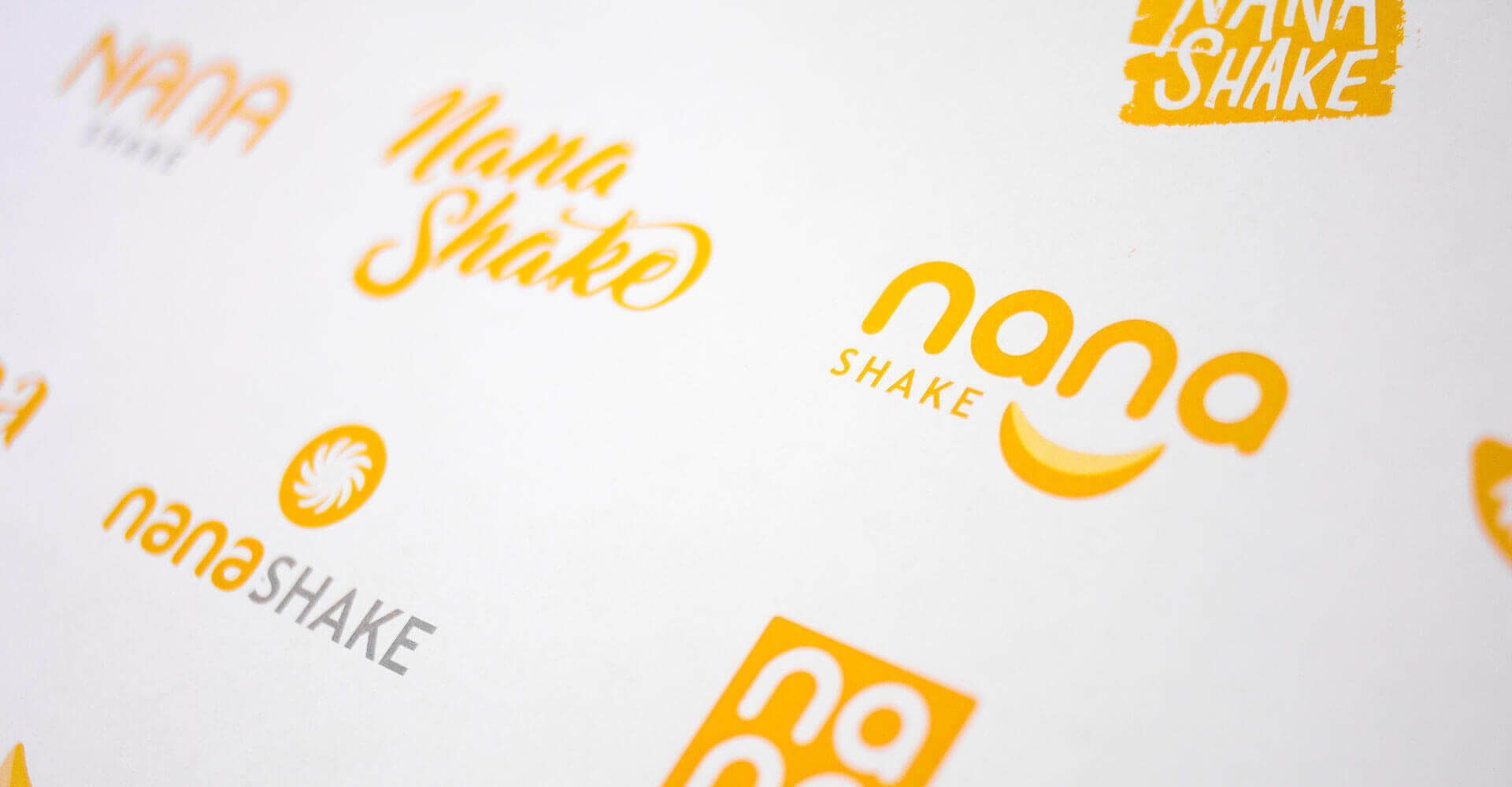 A bunch of logos for nana shake are on a white surface.