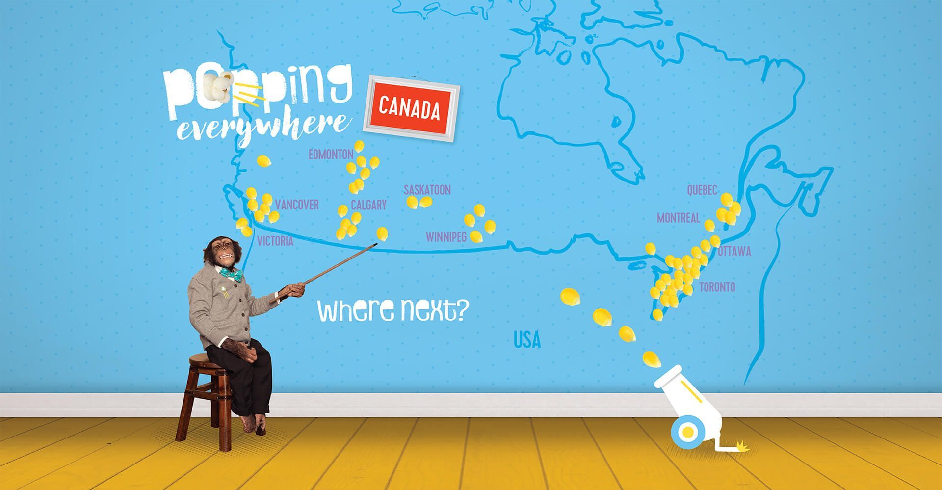 A woman is sitting on a stool in front of a map of the world.