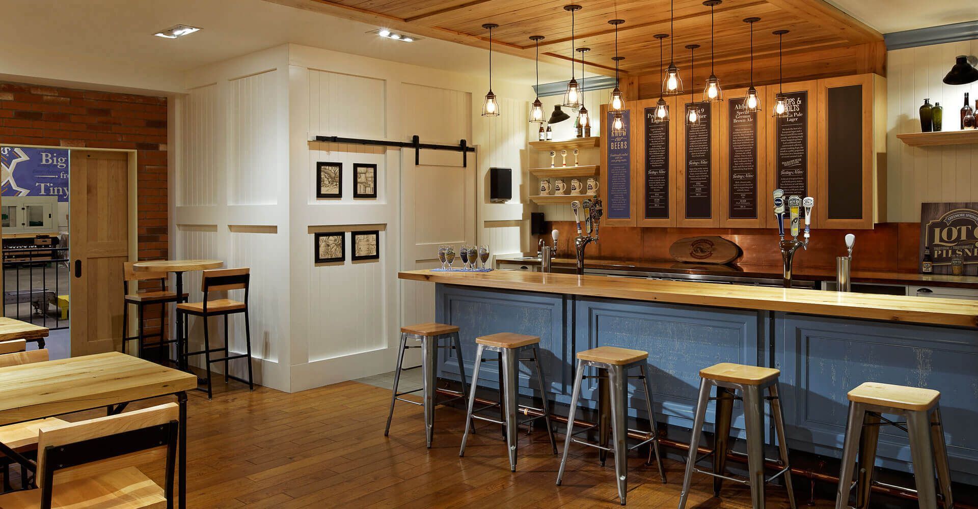 A kitchen with a long blue counter and stools