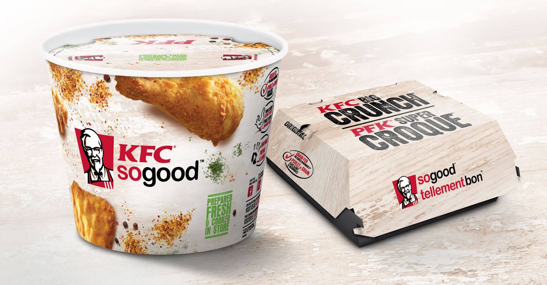 A cup of fried chicken next to a box that says kfc so good