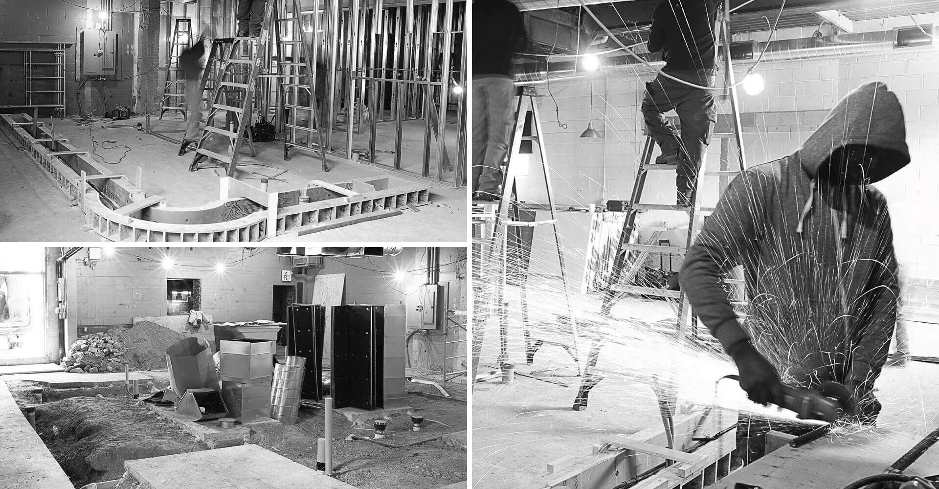 A black and white photo of a construction site with a man in a hood.
