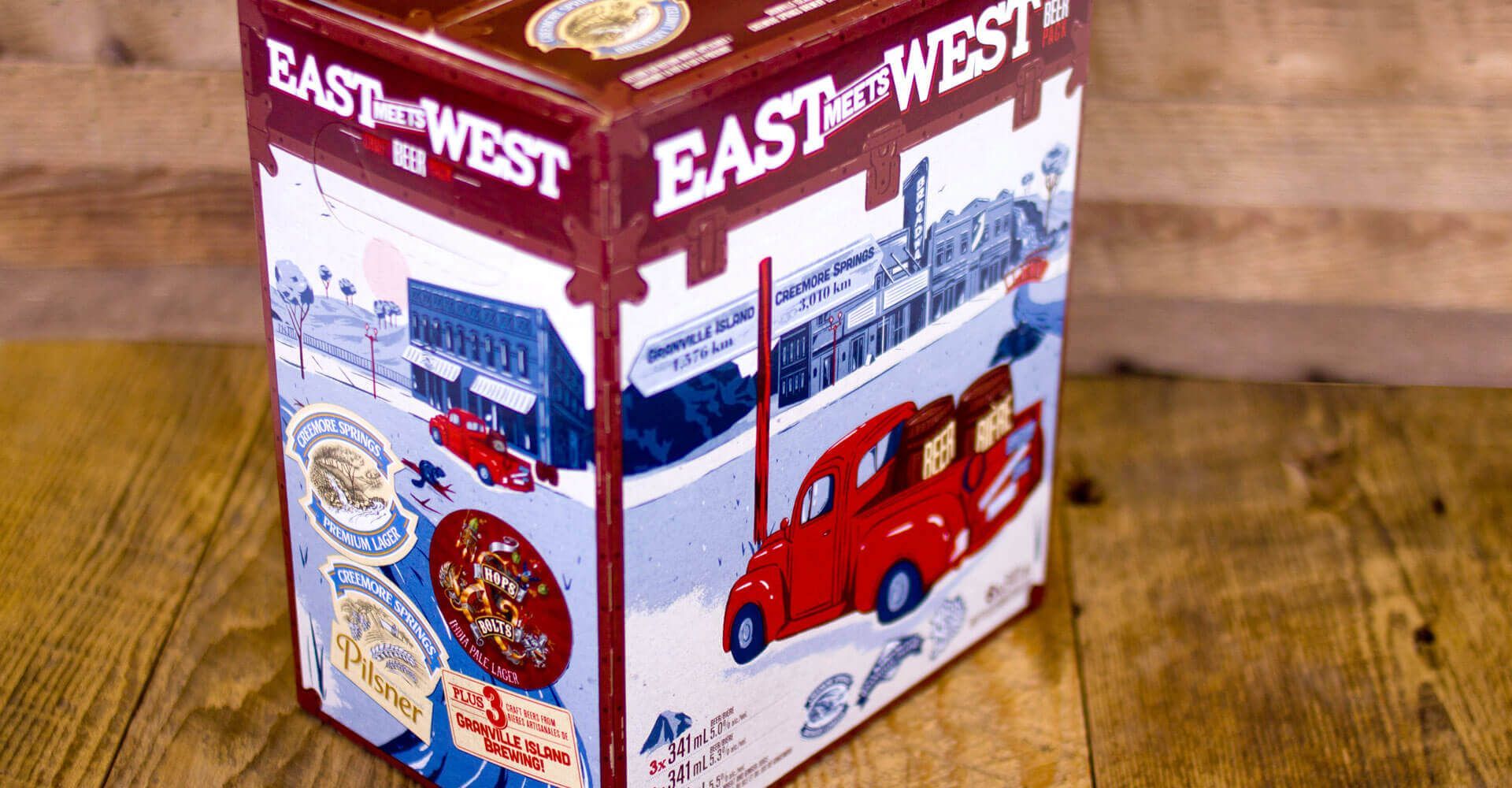 A box with a red car on it is sitting on a wooden table.