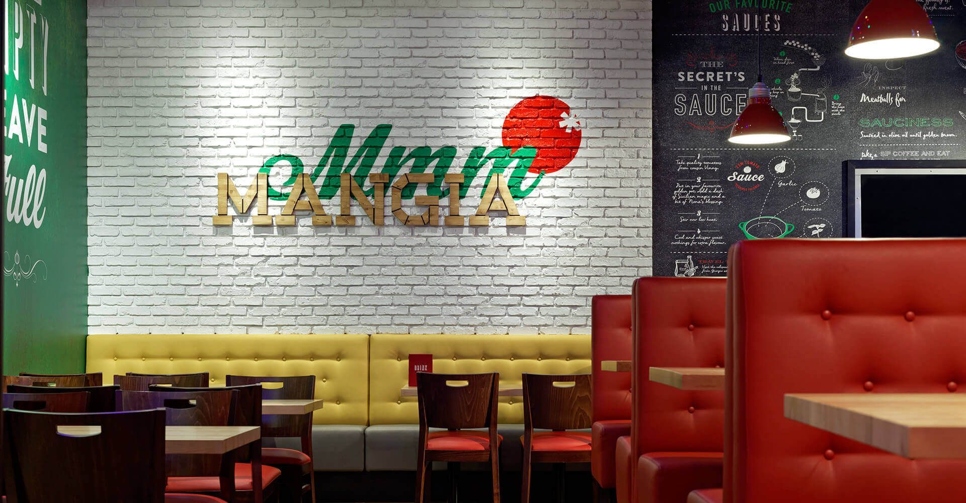 A restaurant with a brick wall and tables and chairs