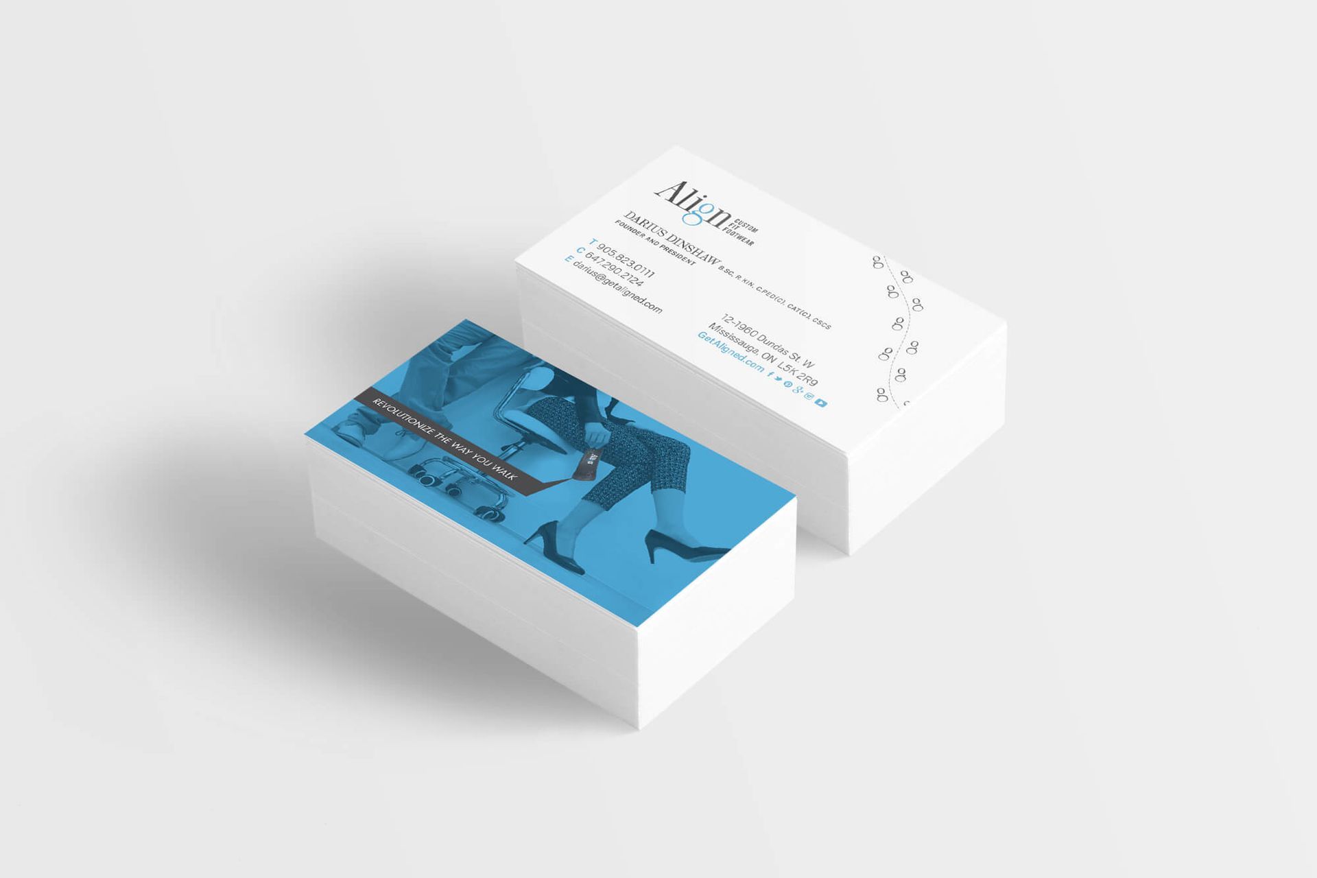 Two business cards are stacked on top of each other on a white surface.